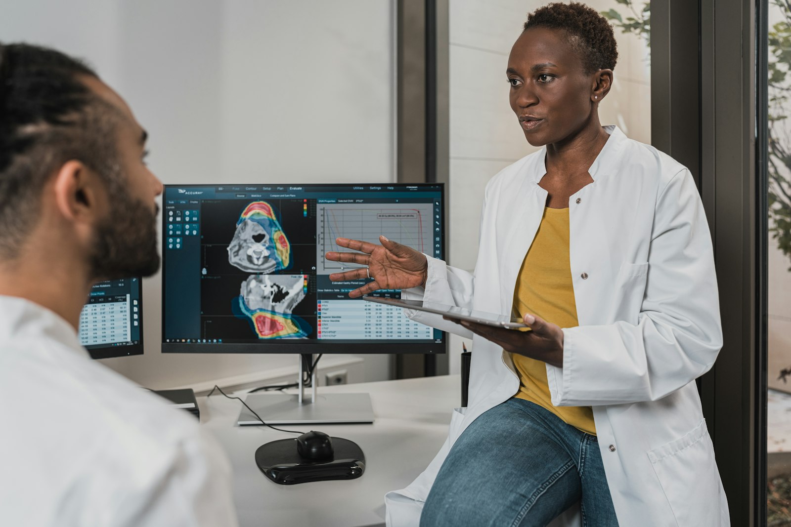 Two clinicians reviewing diagnostic imaging together at a workstation